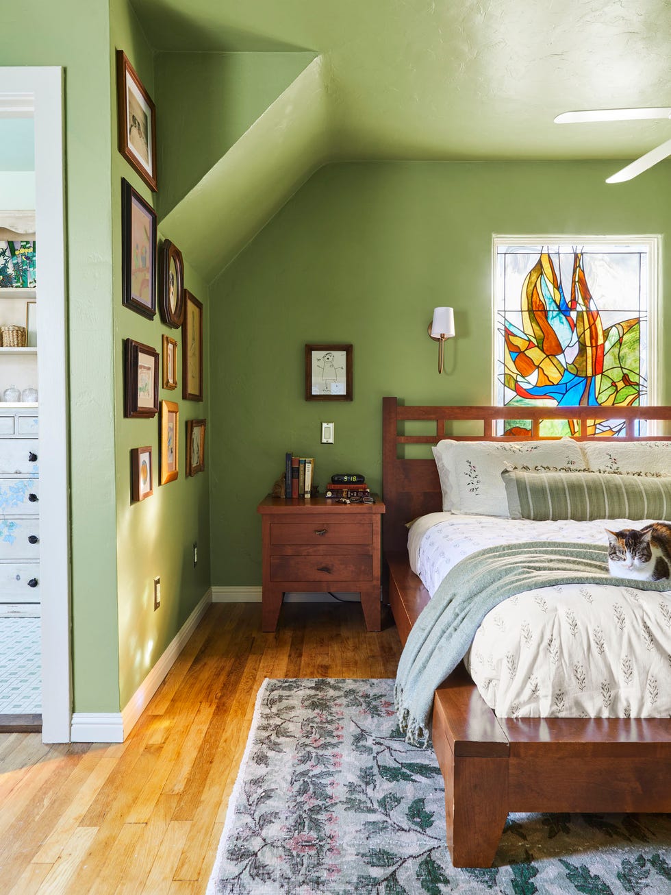 green bedroom with dark wood furniture