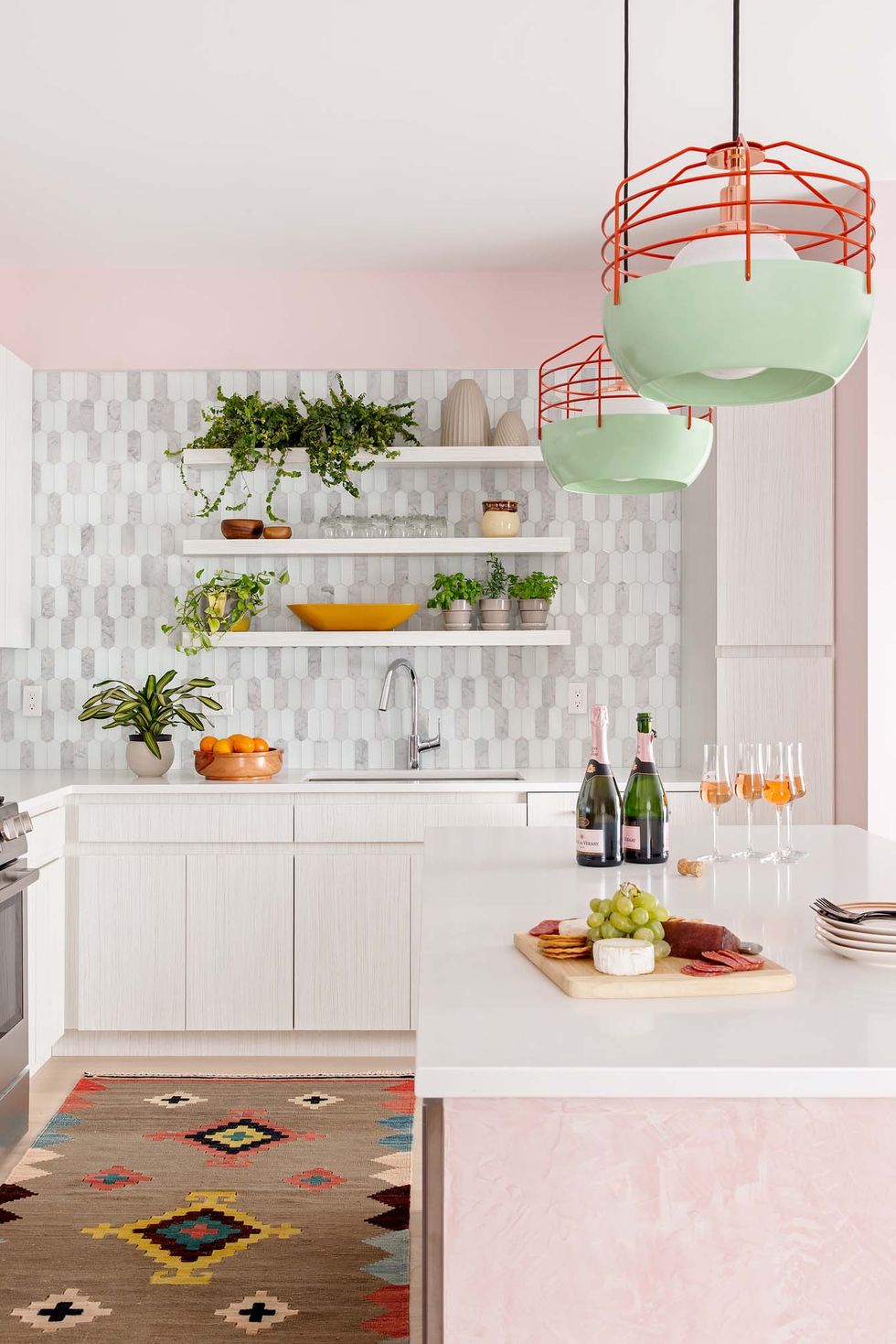 kitchen with pink island and pink walls