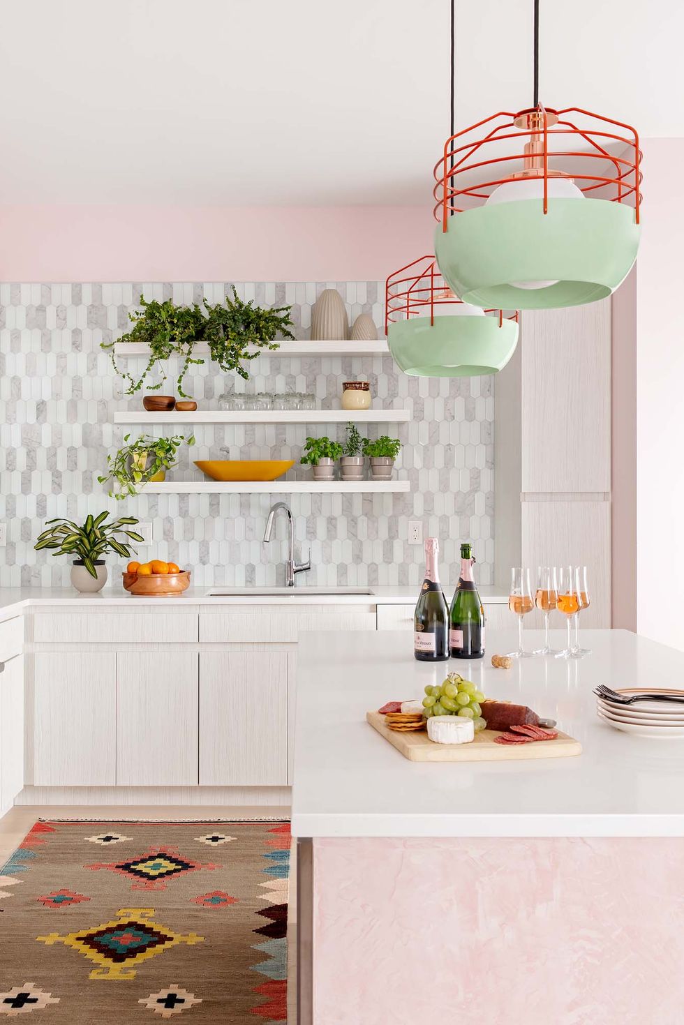 kitchen with pink island and pink walls