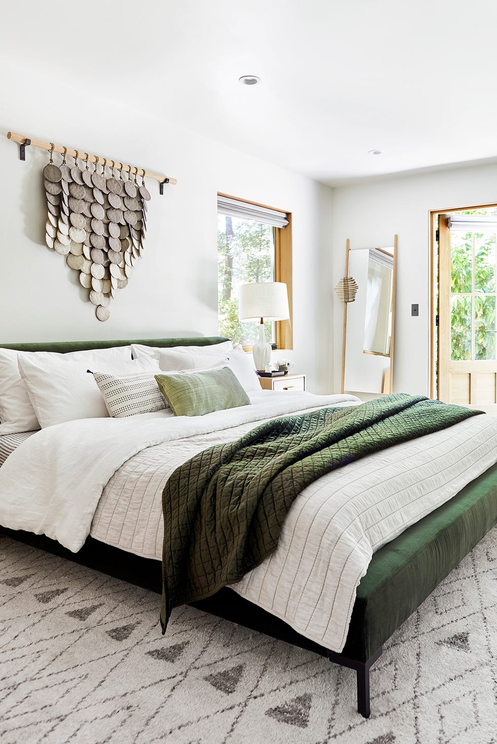 Bedroom featuring a modern design with a bed decorative wall art and large windows bedroom featuring a modern design with a bed decorative wall art and large windows