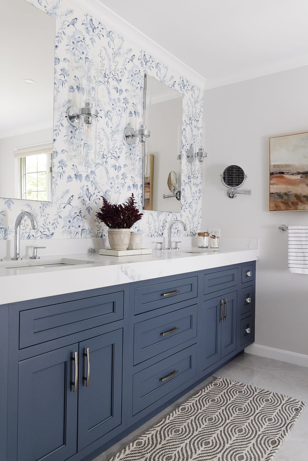 blue bathroom with botanical wallpaper over blue vanity