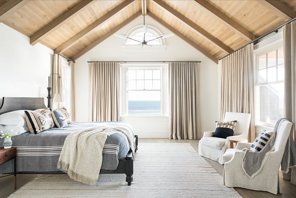 a bedroom with slipcovered chairs
