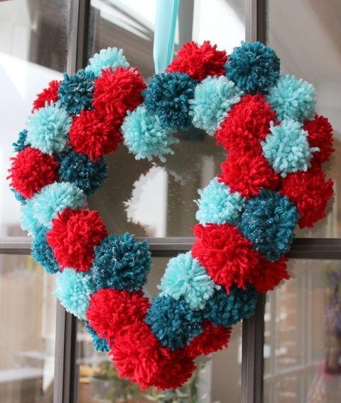 heart shaped wreath made of red, dark blue and light blue pom poms