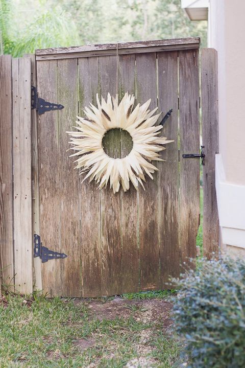corn husk wreath hanging on wooden door