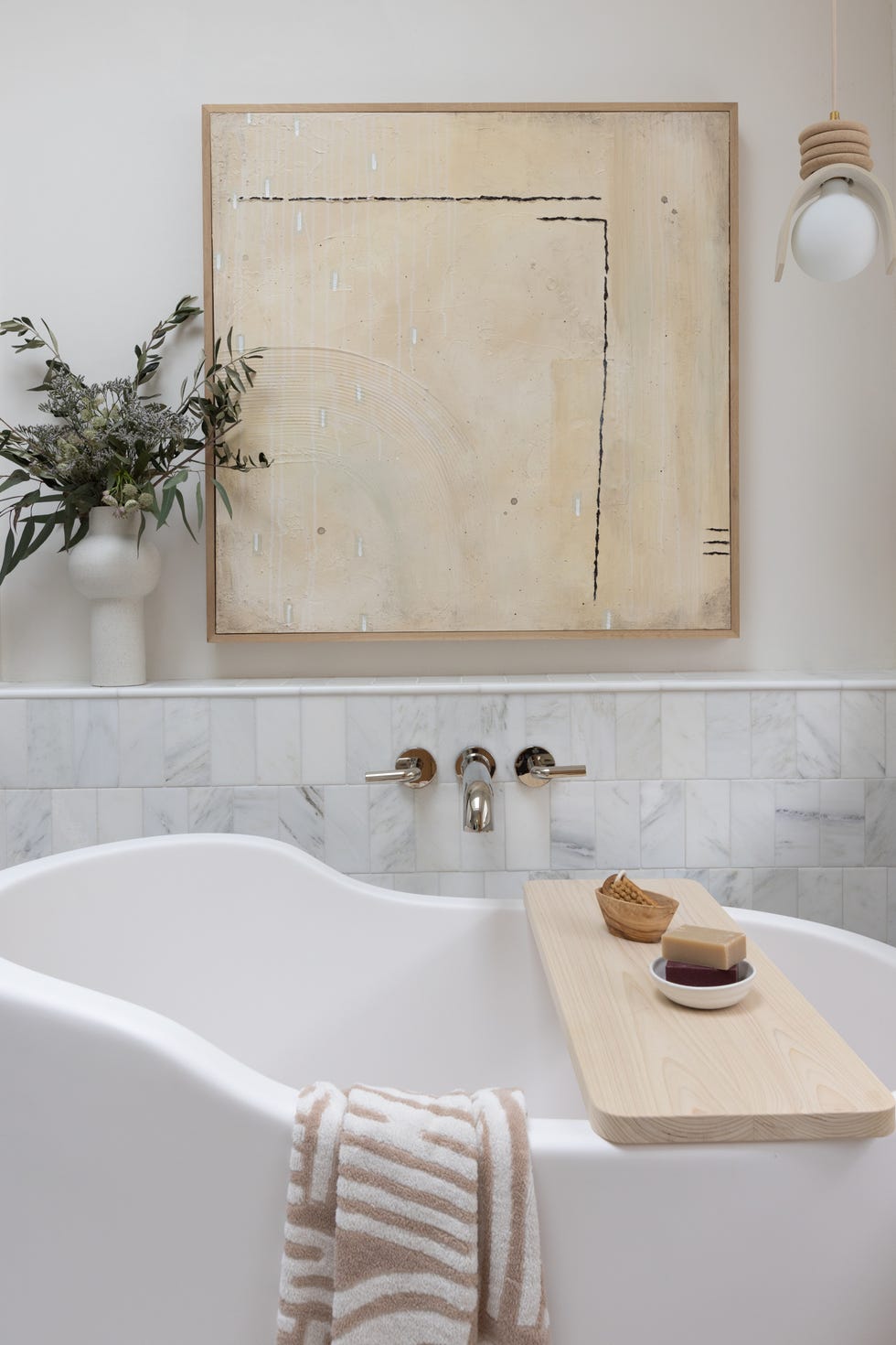 soaking tub with large artwork over tub