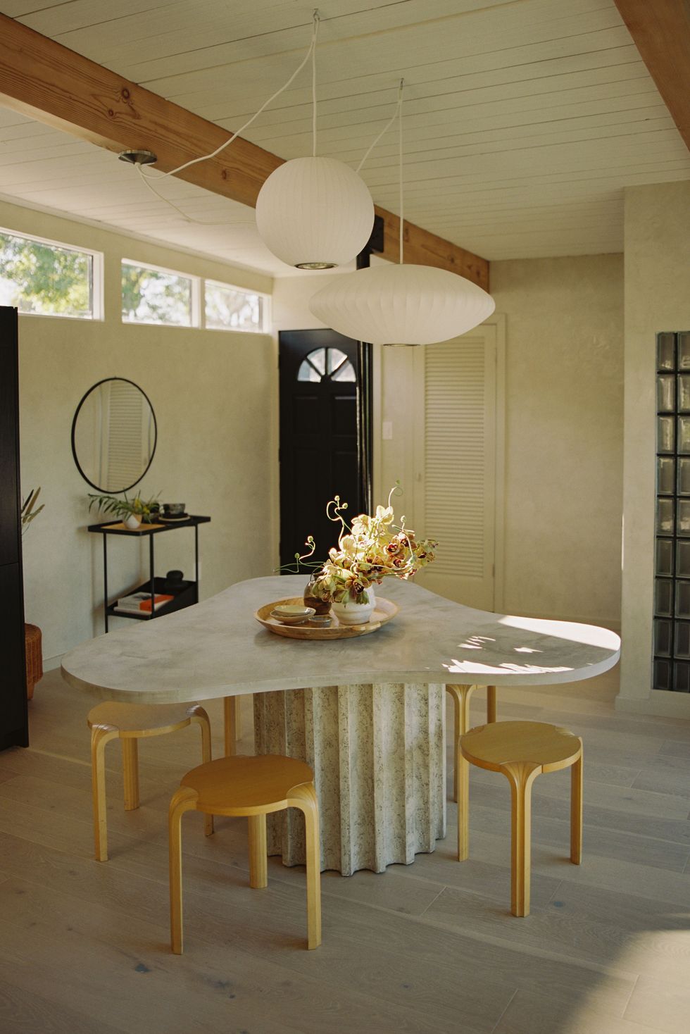 a dining room table with a mirror