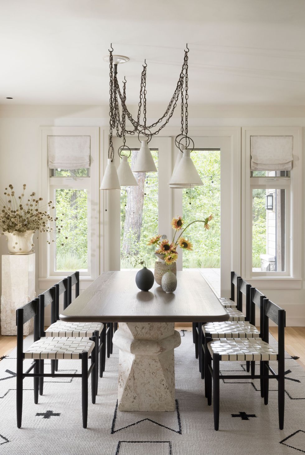a dining room table with chairs and a chandelier