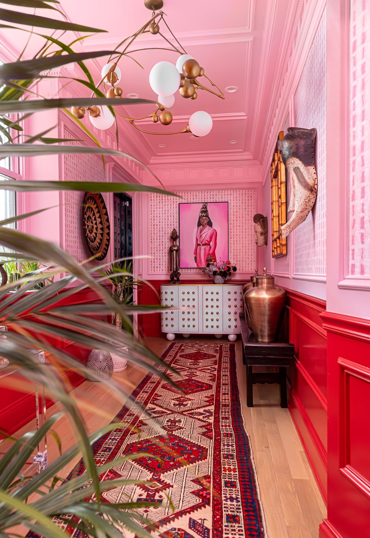 pink and red hallways with artifacts and wallpaper