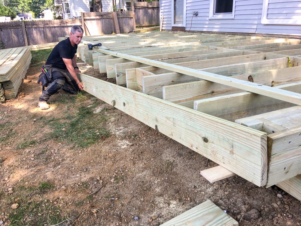 man building wooden deck