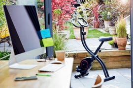 desk in home office and exercise bike