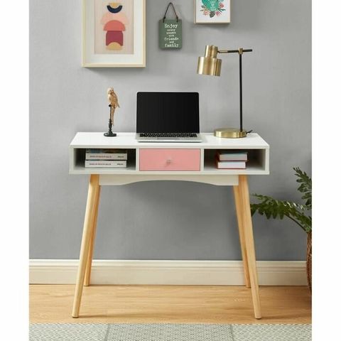 This is a white desk with pale wooden legs and a pale pink drawer and two storage cubbies.