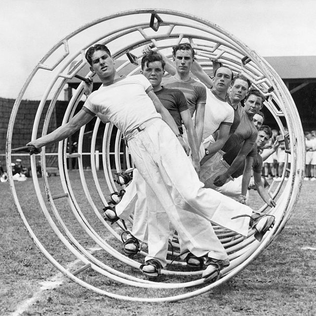 original caption nine men exercising in a hoopla wheel, a long metal rolling jungle gym undated navy photograph photo by george rinhartcorbis via getty images