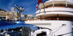 detail of rolls royce parked in front of luxury yacht, port hercule