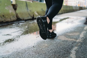 detail of the feet of a woman while she's running in the city