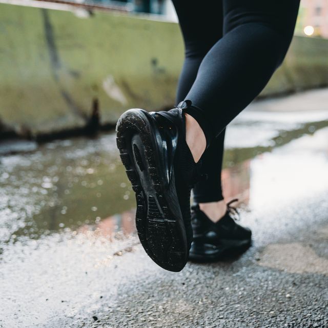 detail of the feet of a woman while she's running in the city