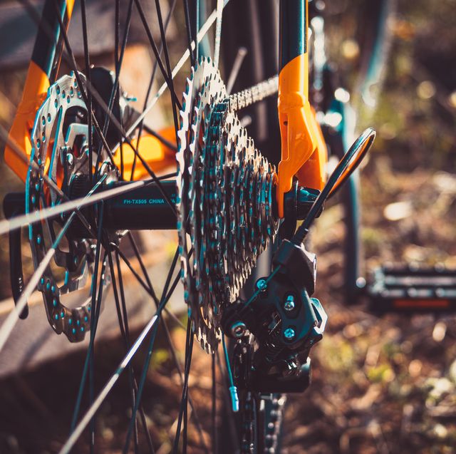 detailed shot of the gear shifter of an orange mountain bike