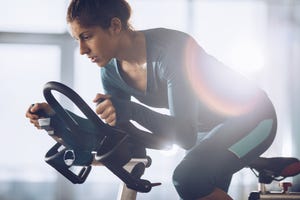 Determined female athlete on a exercising class in a health club.