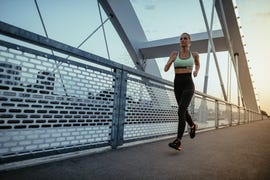 determined mature woman jogging in the evening