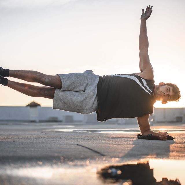 Determined young man exercising in plank position