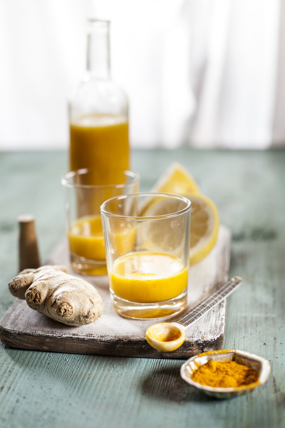 Detox drink, ginger, lemon and orange juice with curcuma and chilli powder