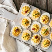 deviled eggs on white ceramic tray with dish towel