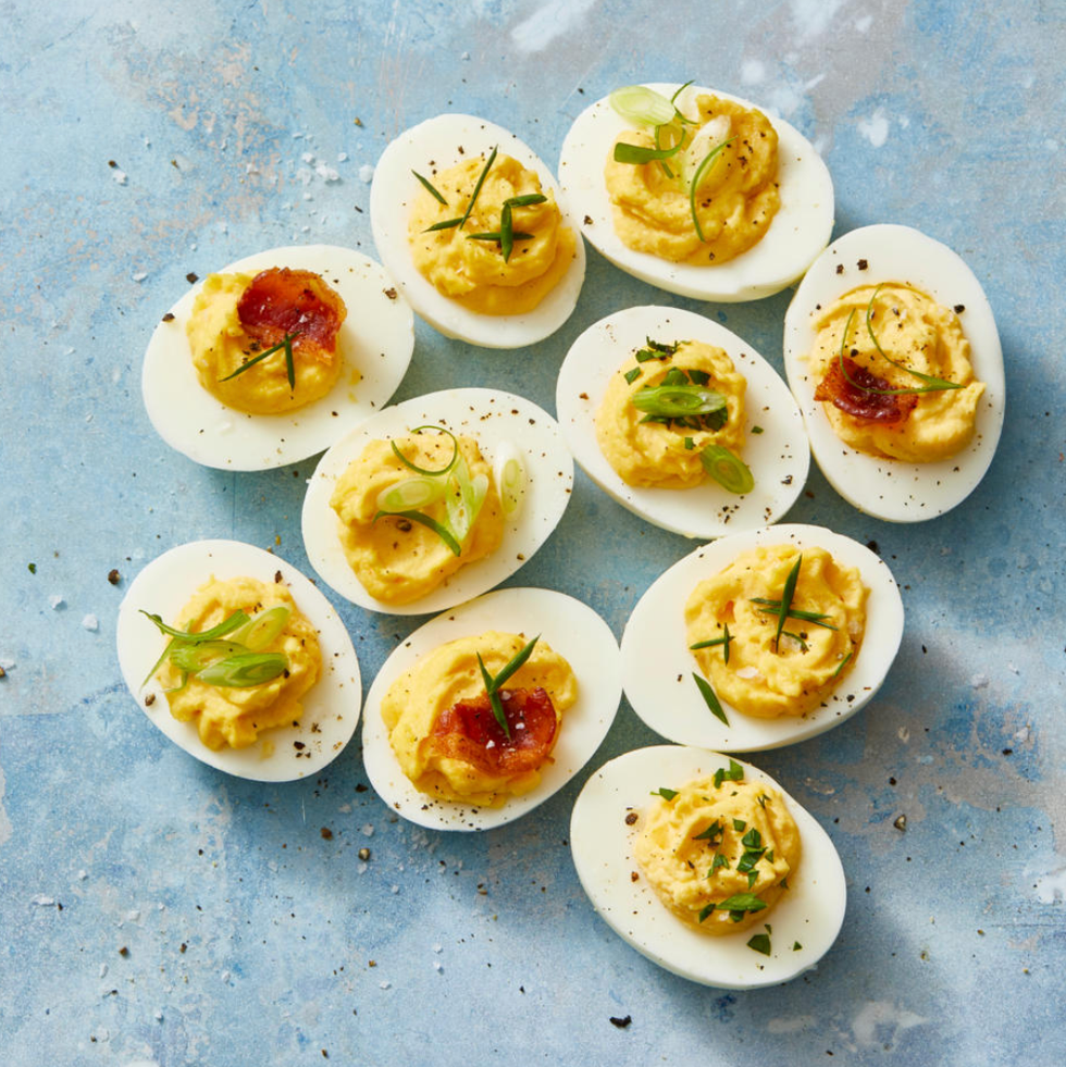deviled eggs with herbs on top
