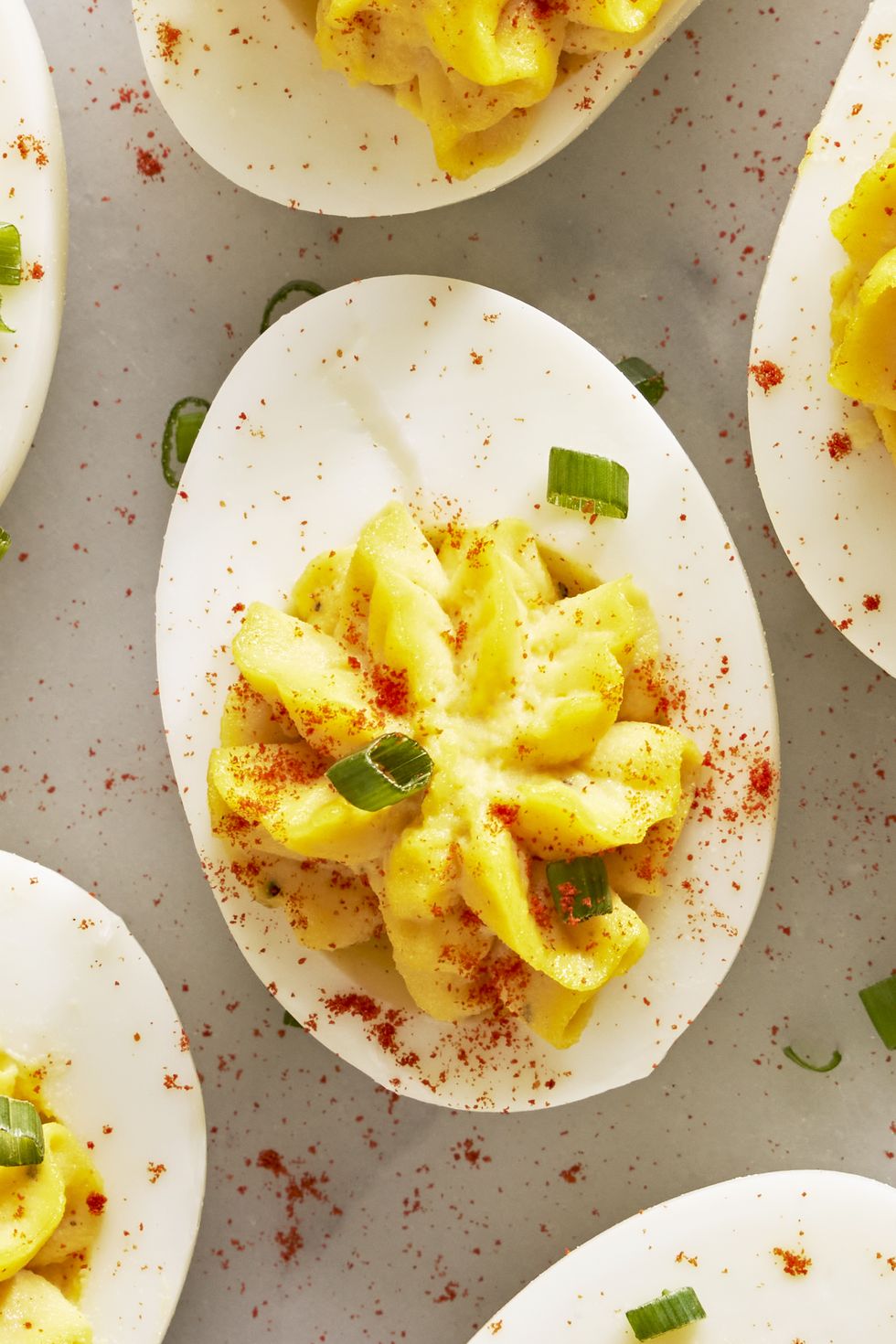 deviled eggs with paprika and sliced chives