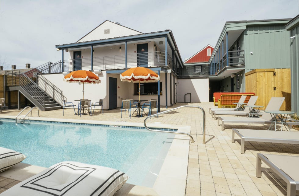 a pool with a deck and chairs by it