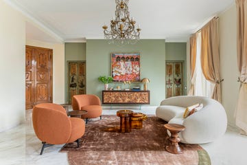 a living room with a chandelier and a bed