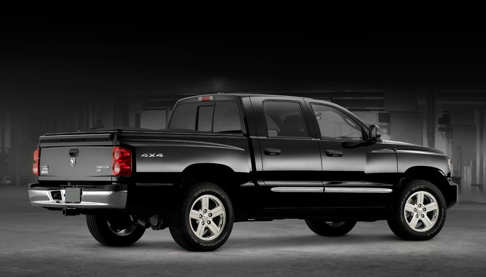 black 2011 dodge dakota pickup truck with a four door configuration sitting in a rear three quarter view