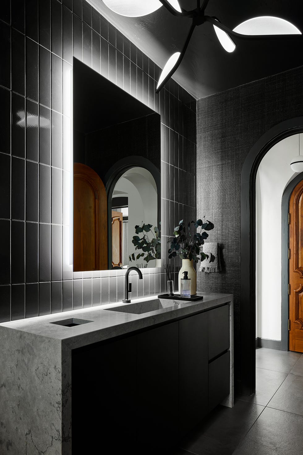 a bathroom with a large mirror a bathroom with a large mirror