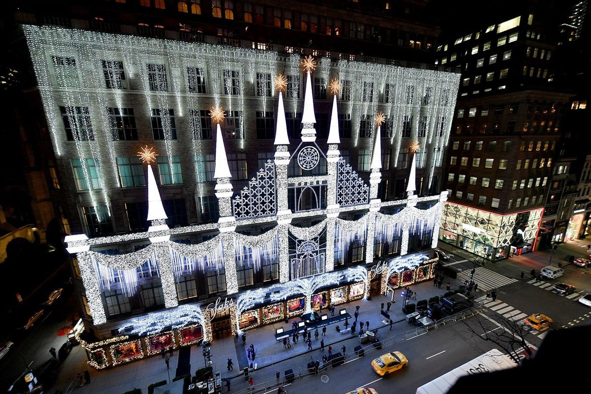 A woman looks at the fashion in the holiday window display at the Louis  Vuitton store on a most …