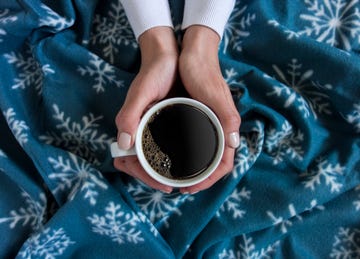 holding a cup of coffee