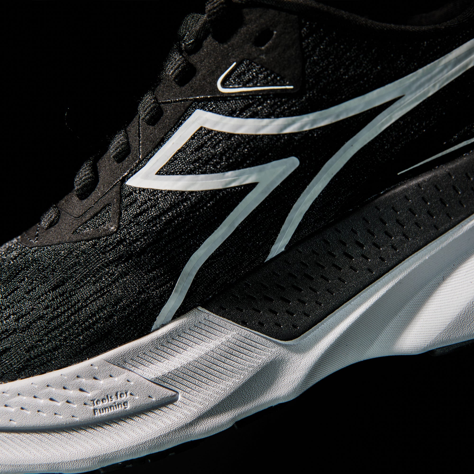 running shoe featuring a sleek black design with white accents