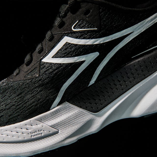 running shoe featuring a sleek black design with white accents