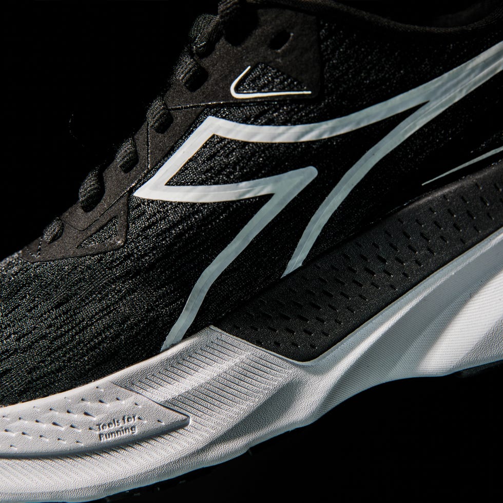 running shoe featuring a sleek black design with white accents