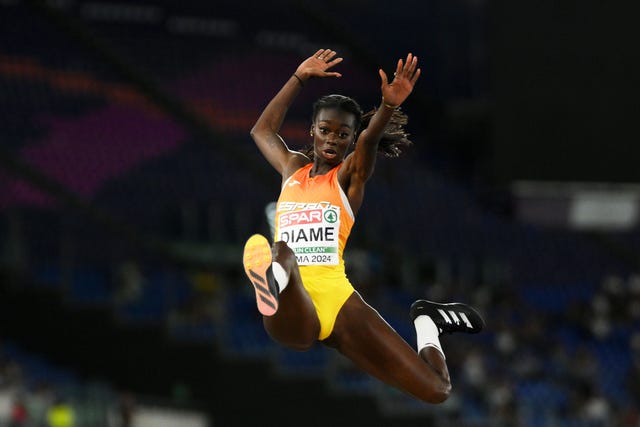 athlete performing a long jump during a sporting event
