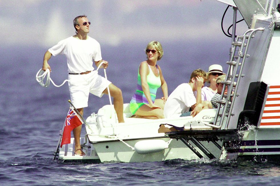 several people in beaching clothes sitting in the back of a boat, wearing sunglasses