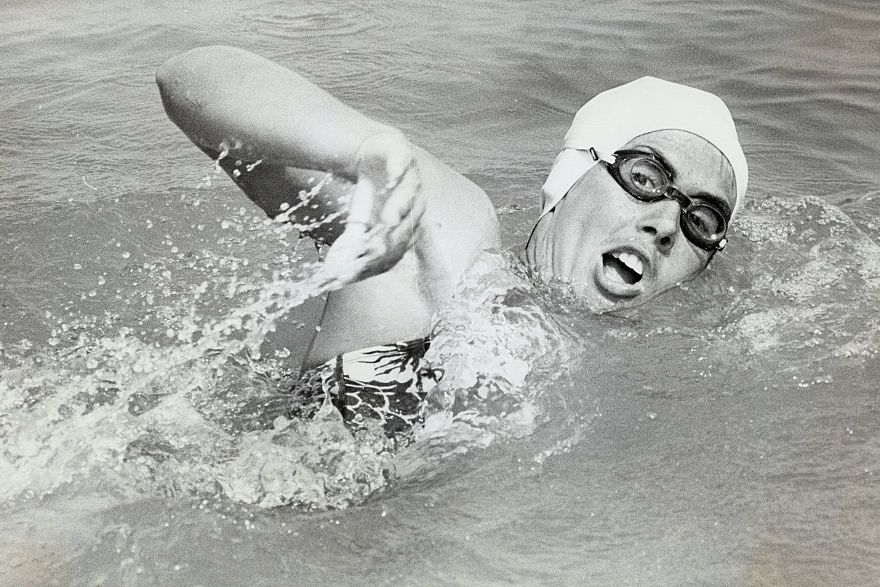 a black and white photo of diana nyad swimming