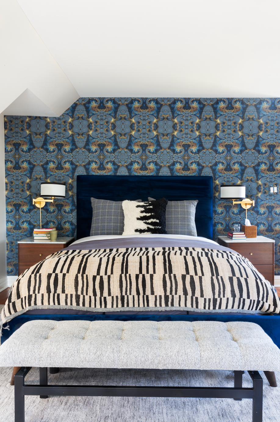 a bed with a blue and white comforter