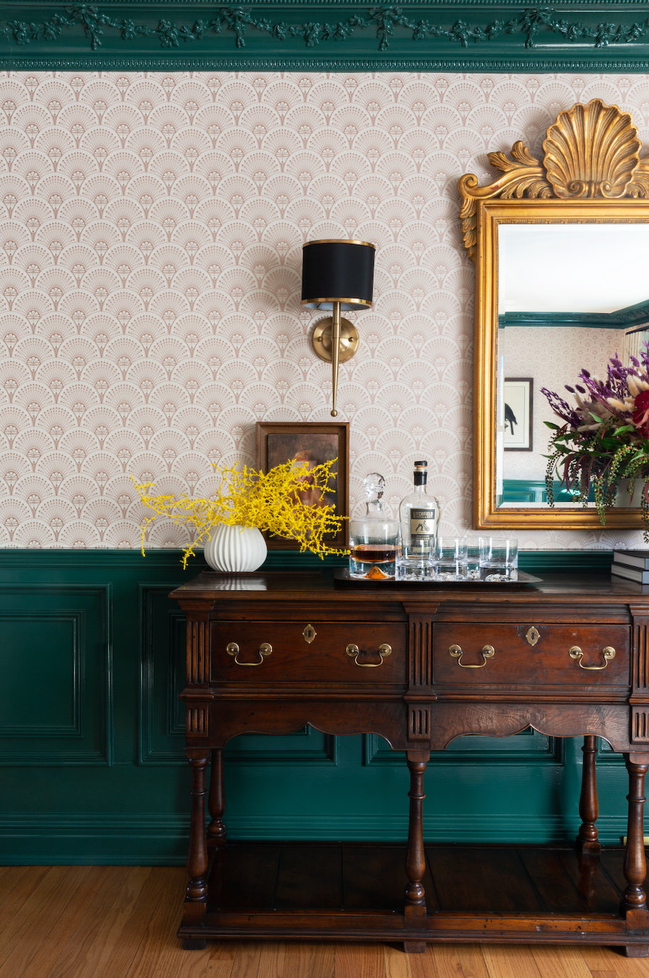 a wooden cabinet with a mirror and flowers on it