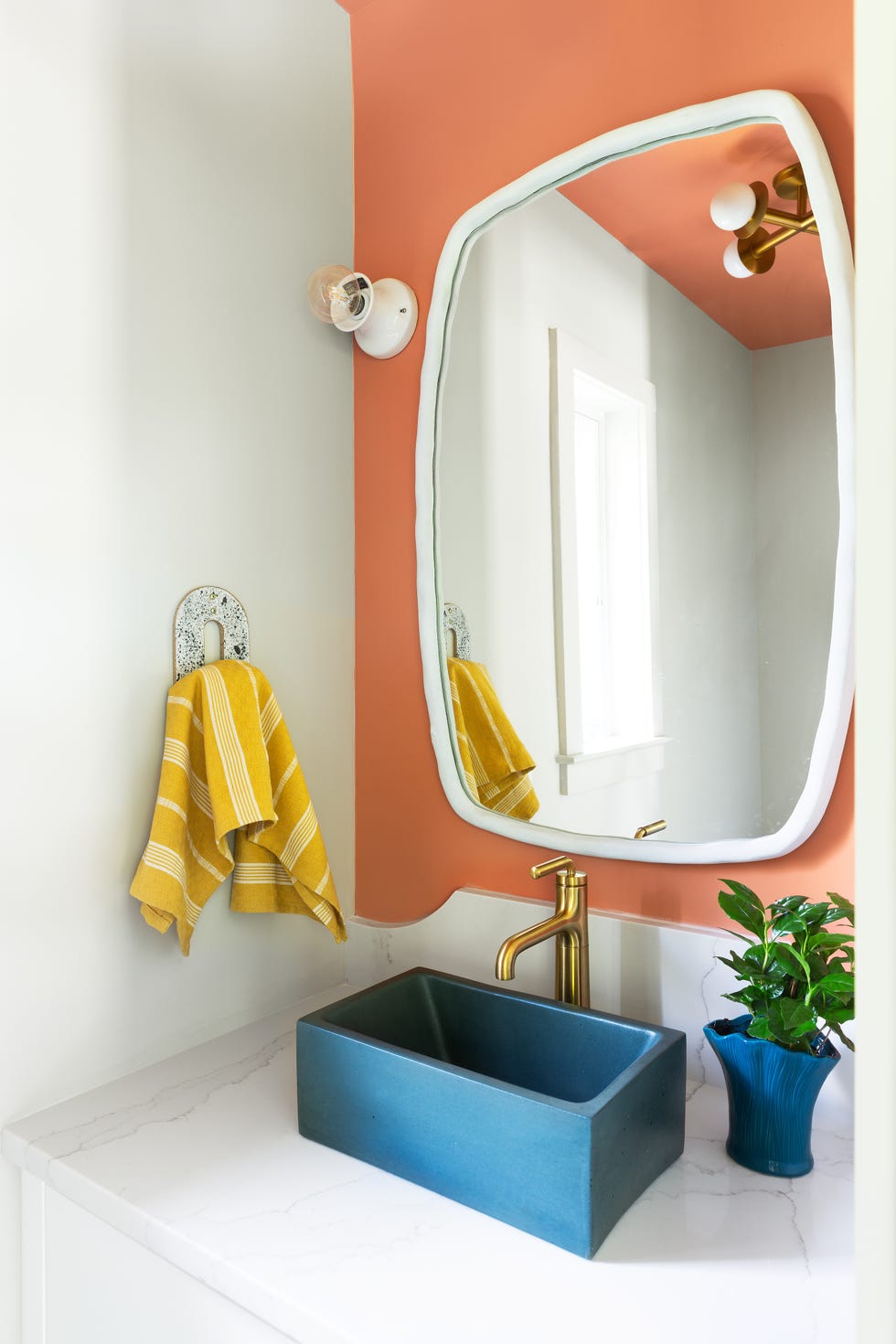 powder room with orange accent wall