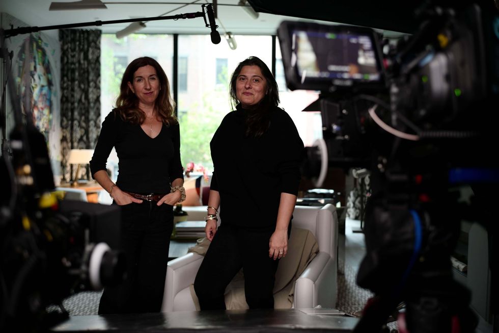 two women posing with filmmaking equipment