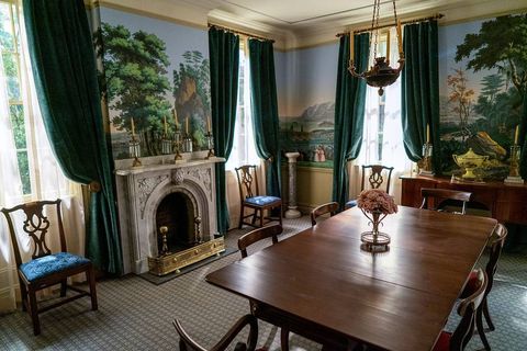 the dining room of the fictional homestead, which features zuber’s “views of north america" wallpaper