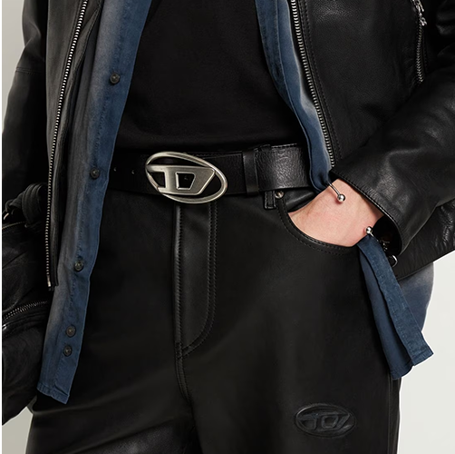 a person wearing a black jacket and a silver belt