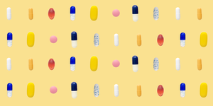 a bunch of different coloredshaped pills in rows on yellow background
