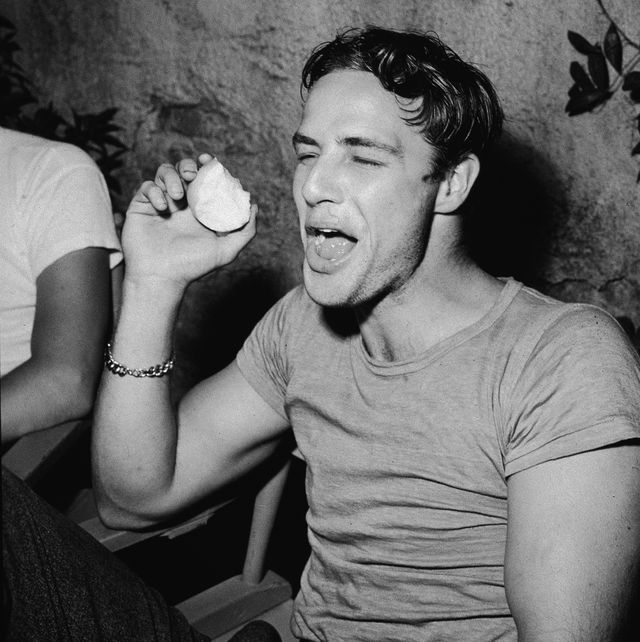 american actor marlon brando laughs while eating an apple during a break on the set of the film, a streetcar named desire, directed by elia kazan, 1951 photo by jack albingetty images 