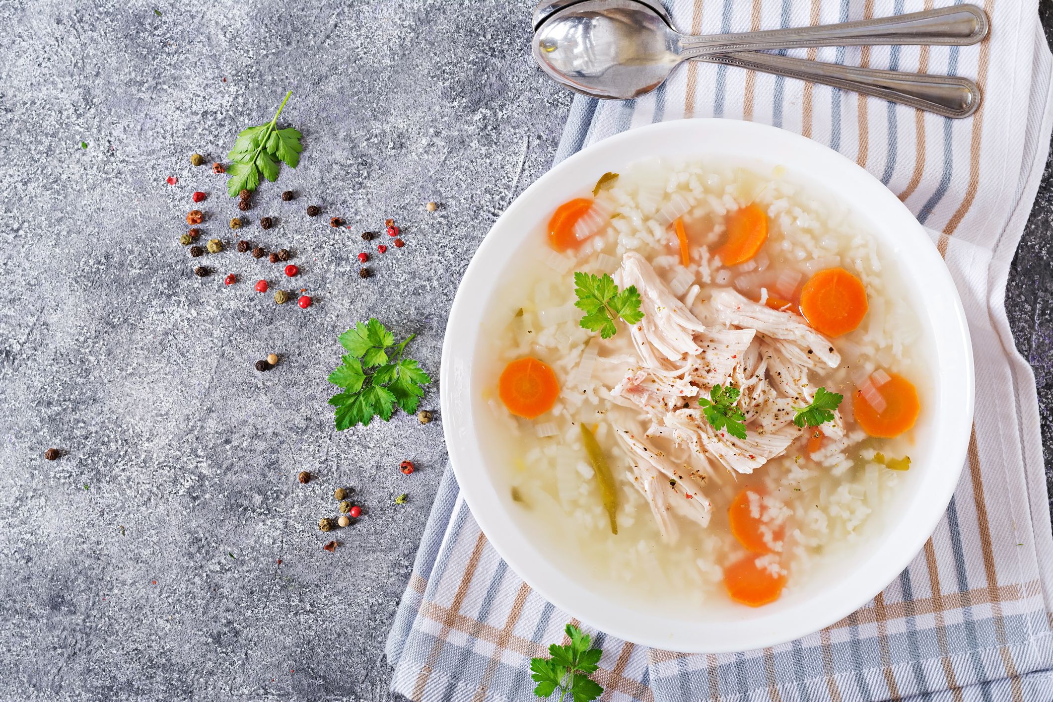 Dietary chicken soup with rice and carrots. Healthy food. Flat lay. Top view