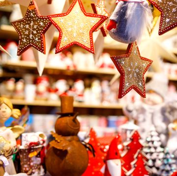 Different decoration, toy for xmas tree on christmas market, close up of cozy handmade gingerbread stars