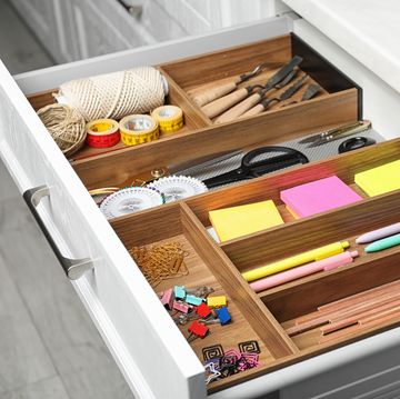 different stationery in open desk drawer indoors